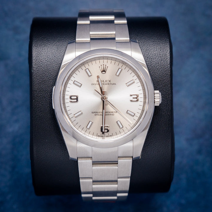 Rolex Oyster Perpetual 114200 Steel Silver Arabic Numerals Dial – front